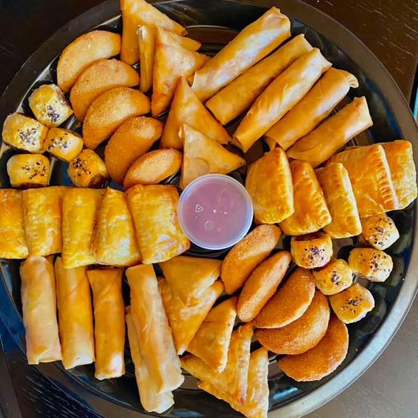 A savoury platter of samoosas, spring rolls, sausage rolls, pies and half moons