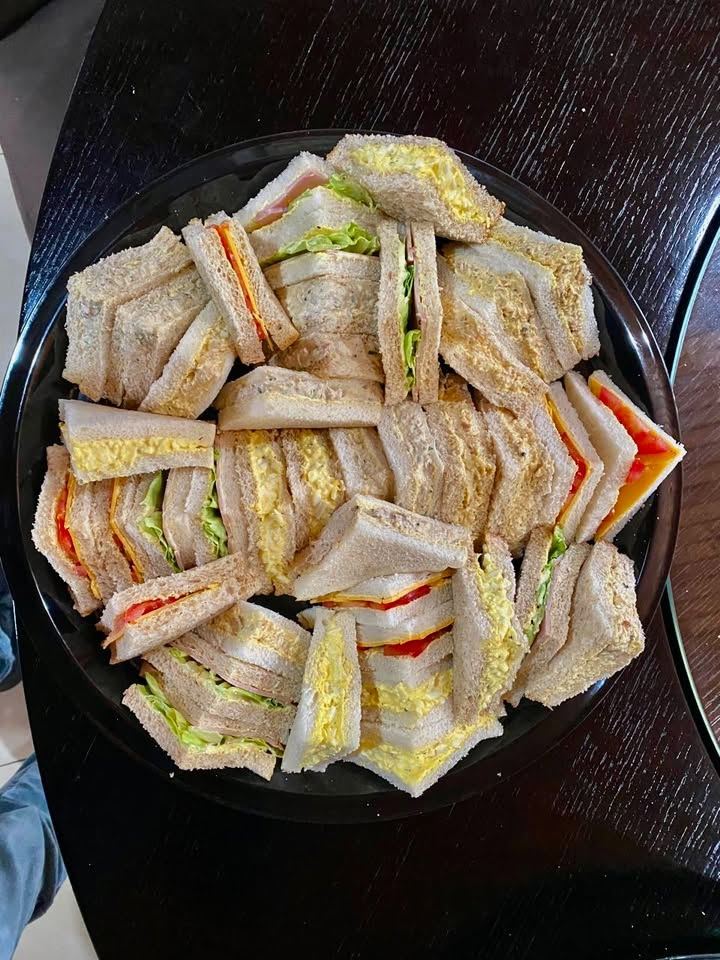 Sandwich platter with egg, cheese and tomato, cold meat and chicken sandwiches